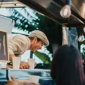 Food truck seller laughing at joke of customers